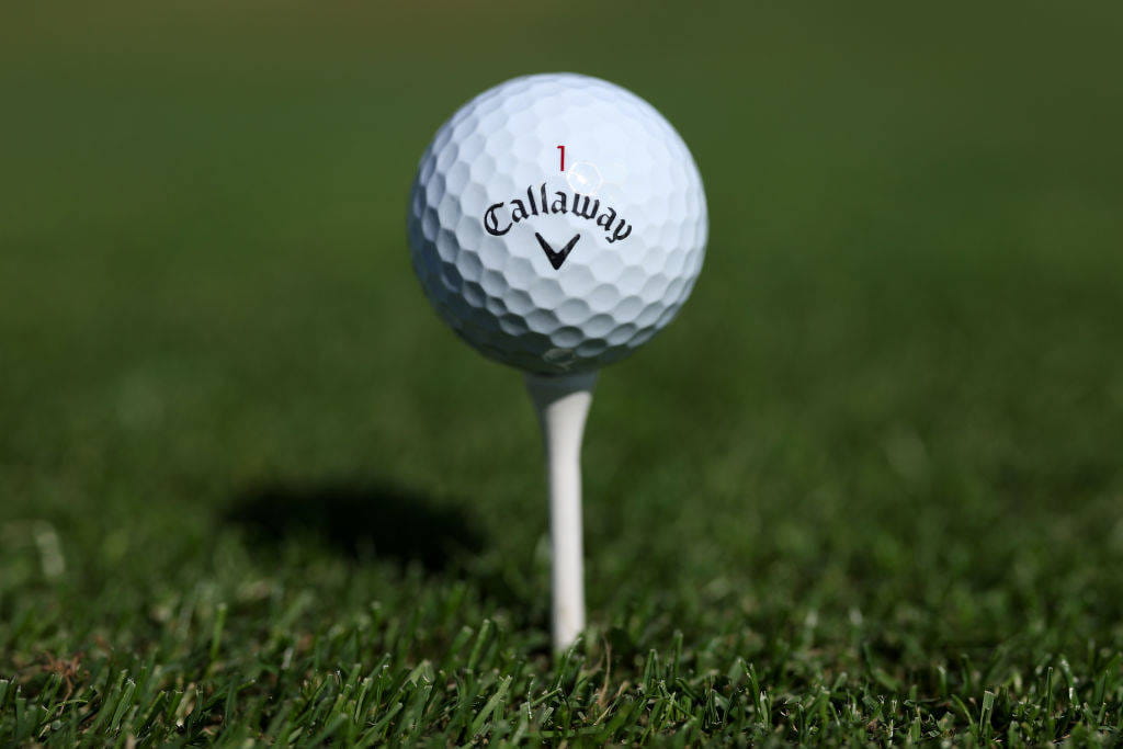 A close up of a Calloway golf ball on a tee